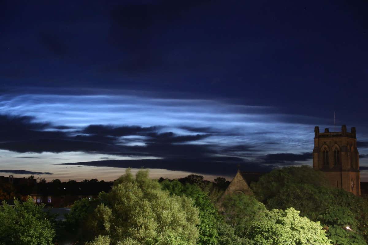 2JFTTMP Noctilucent Clouds seen from Newcastle City Centre with Jesmond Parish Church a grade II listed building designed by the famous architect John Dobson in 1861, Newcastle upon Tyne, UK, 5th July, 2022, Credit: DEW/Alamy Live News